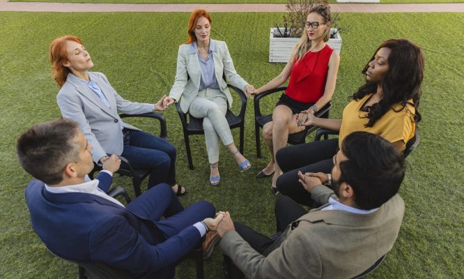 generational, multiracial business people sitting in circle having group discussion, group therapy