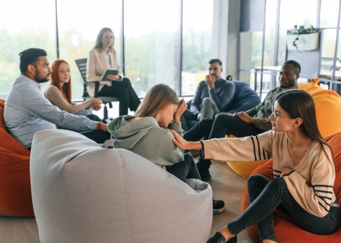 Help of the other people by control of counselor. Therapy meeting.