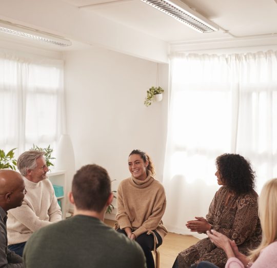 Woman Speaking At Support Group Meeting For Mental Health Or Dependency Issues In Community Space